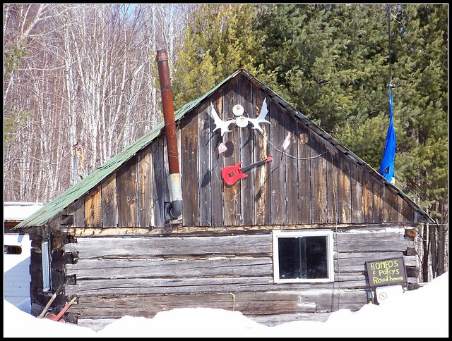 Wooden shed, decorated with antlers and an electric guitar