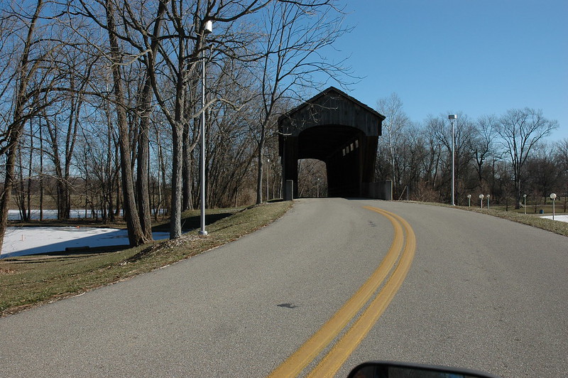 Approaching the covered bridge in Mill Race Park, Columbus, Indiana, from the west. This single span Long Truss structure was originally built in 1840 by Adam Mason near Brownsville in Union County, where it crossed the East Fork of the Whitewater River.