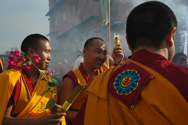 Colorful Lotus Patch, formal robes of delighted monks bearing flower and incense offerings, Bodhisattva Day, Tharlam Monastery Courtyard, Boudha, Kathmandu, Nepal