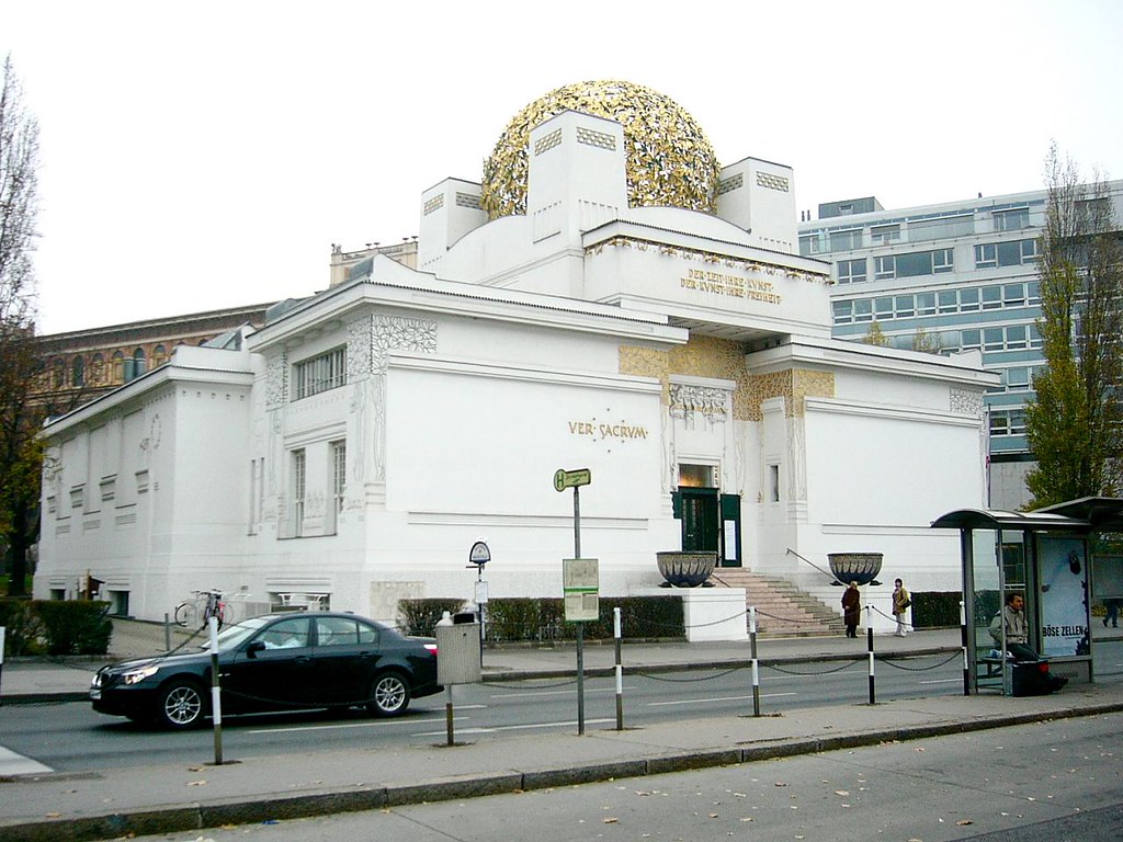 The Secession Building, 1897-1898, J. M. Olbrich: A large white bulidng with a gold dome along the roof. 