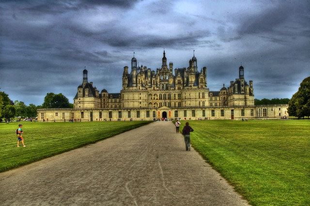 The way of Castel of Chambord in a grey sky with clouds