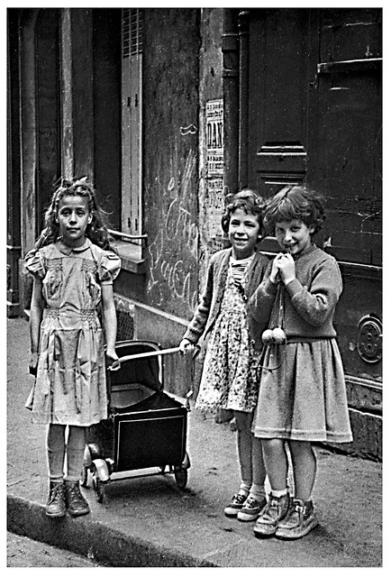 Vintage B&W. May 1955. Paris (France). Little girls at a doll's pram.