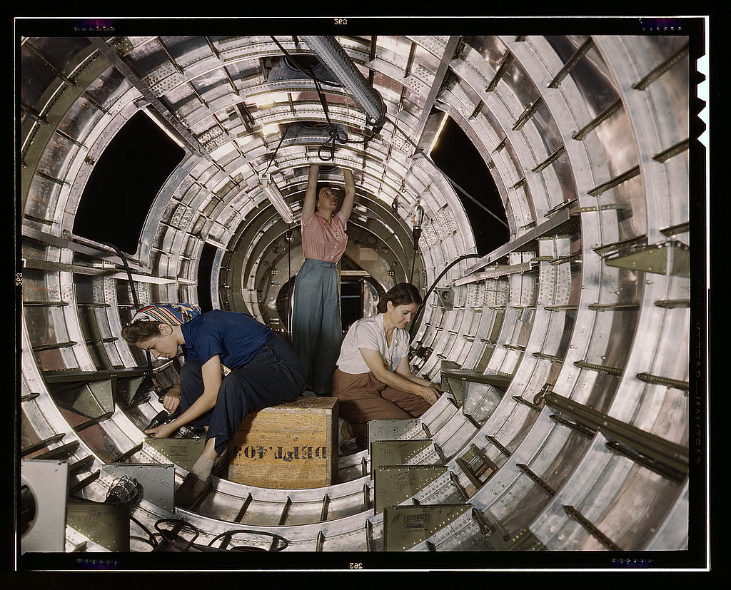 Women workers install fixtures and assemblies to a tail fuselage section of a B-17F bomber at the Douglas Aircraft Company, Long Beach, Calif. Better known as the "Flying Fortress," the B-17F is a later model of the B-17 which distinguished itself in acti