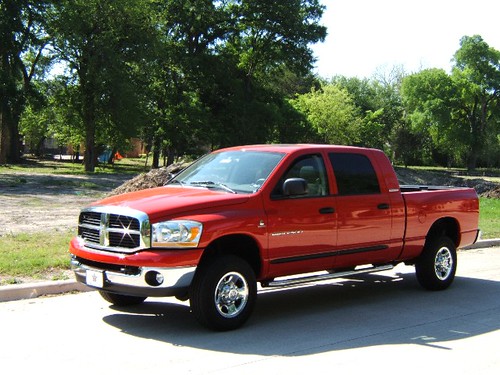 Red Dodge Ram truck parked on street