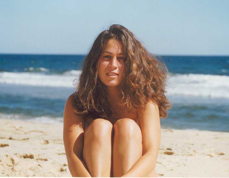 Beautiful woman, hair, sand and sea
