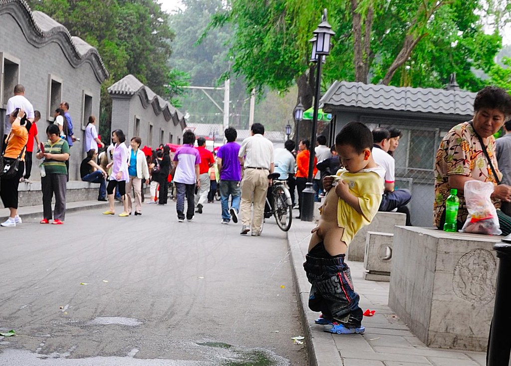 kid peeing on the street.