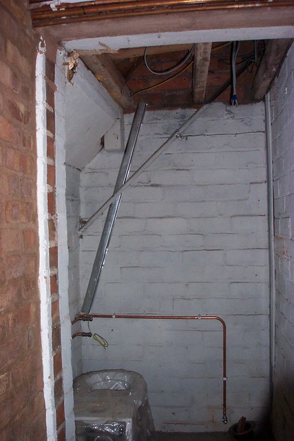 The old storage space under the stairs waiting to be turned into a cloakroom