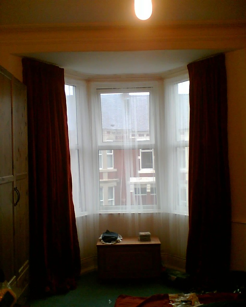 Curtains beautifully framing a bay window with natural light