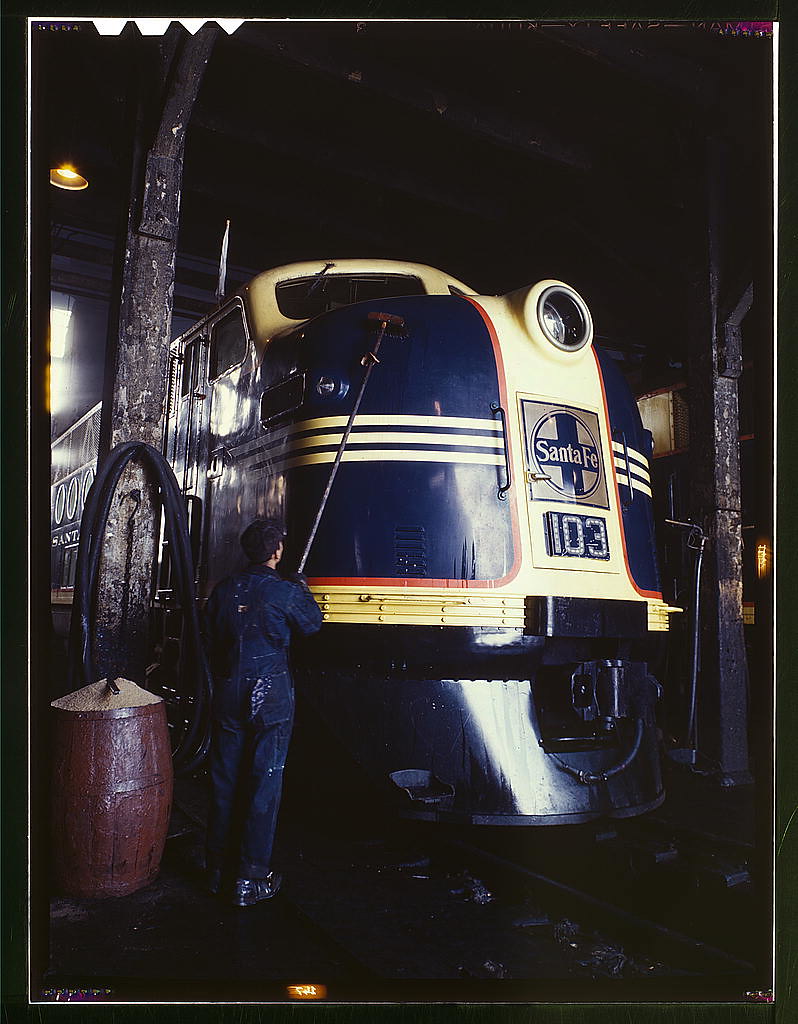 Washing one of the Santa Fe R.R. 54 hundred horse power diesel freight locomotives in the roundhouse, Argentine, Kansas. Argentine yard is at Kansas City, Kansas  (LOC)