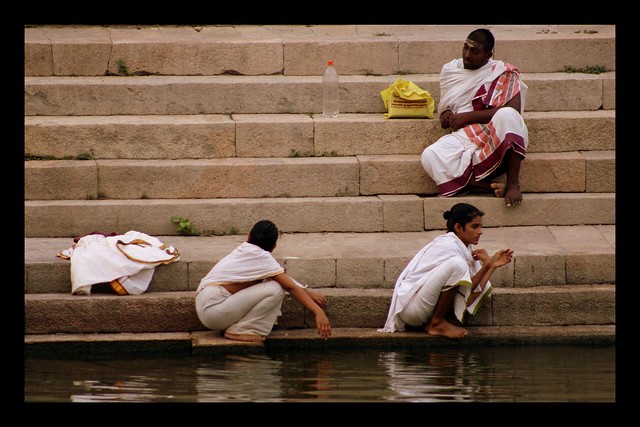 young priest relax in temple pond