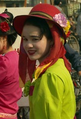 Dai girl in red hat; Market at Menghum, Xishuangbanna, Yunnan, China
