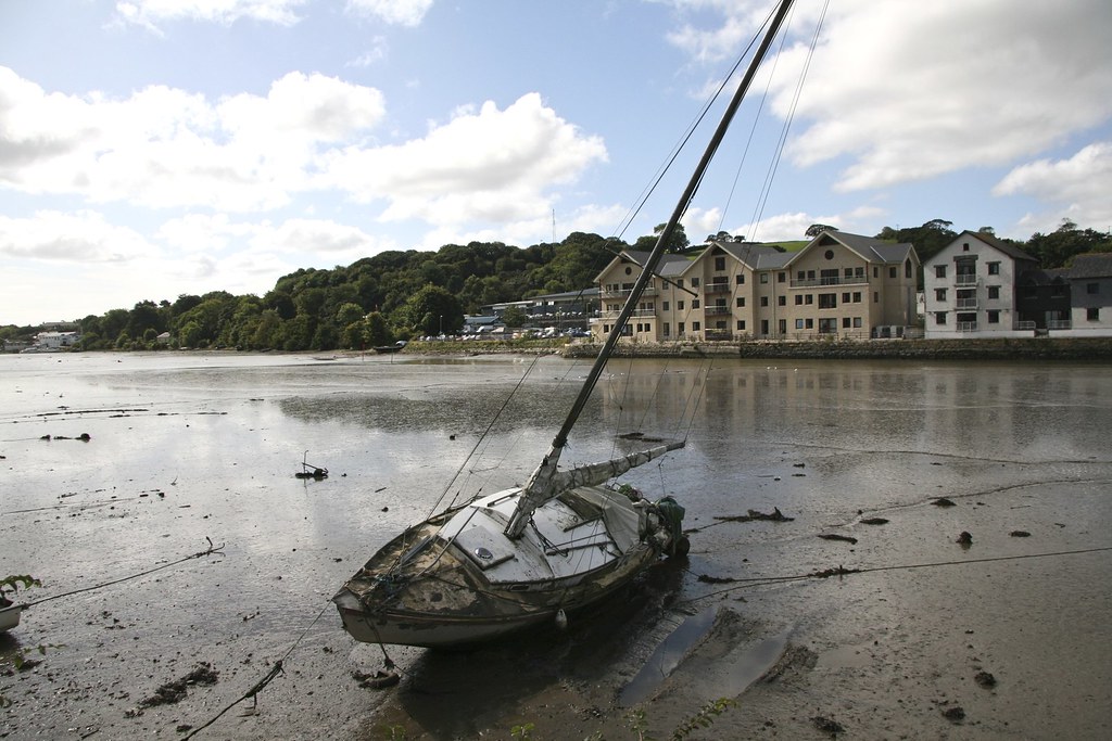 Truro Riverbank life. Malpas side. Decaying yacht moored on the mud.