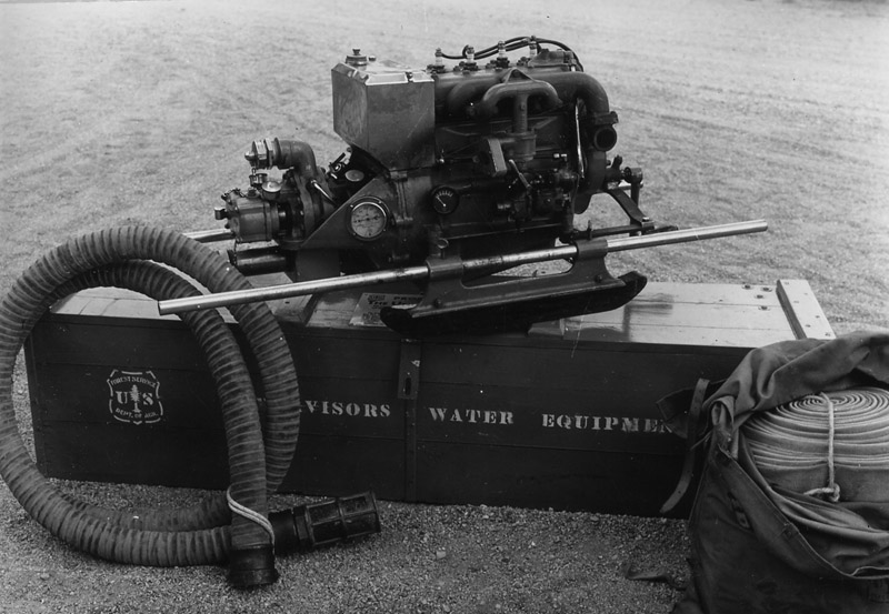 Marine fire pump and hose unit in fire cache.