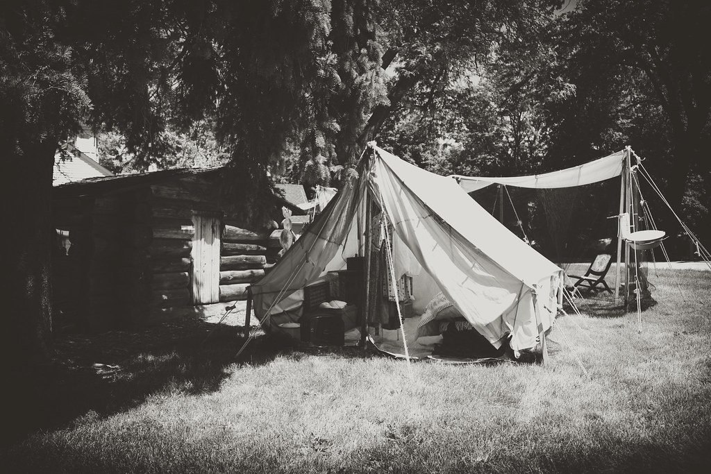 1860's Lifestyle - Camp - a tent pitched in the sun on a grassy field