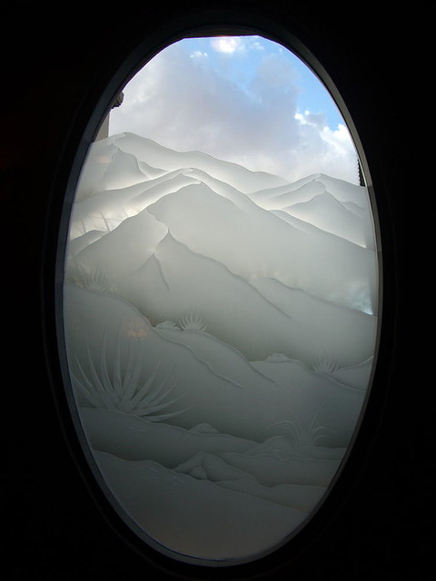 etched decorative glass window desert mountains boulders foliage