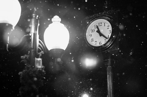 street light blackandwhite bw snow fall clock night brighton michigan main lamppost 1122pm