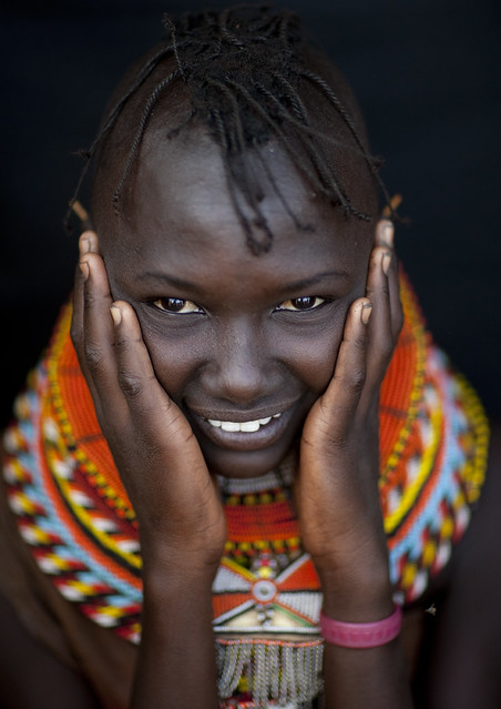 Turkana tribe girl with hands on cheeks - Kenya