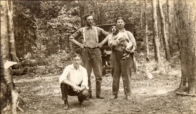 Three men and dog, circa 1920