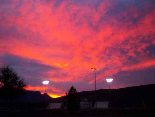 100_8129 by Matt Hays, Stadium lights created and interesting affect on the sky colors.santa county pink blue sunset red ar