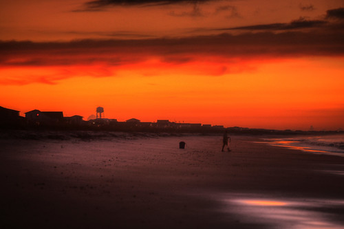 orange sun beach water sunrise person fisherman sand waves glow northcarolina oakisland