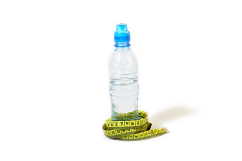 Bottle and metric measuring tape