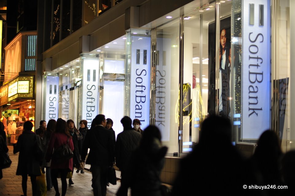 People walking past the Soft Bank building heading down towards the illuminations.