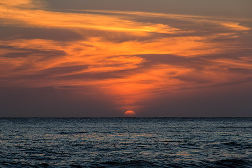 landscape seascape sunset evening dusk clouds ocean sea caribbean water waves sky orange cartagena bolivar colombia birds