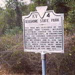 Original Seashore State Park sign with a forest behind. 