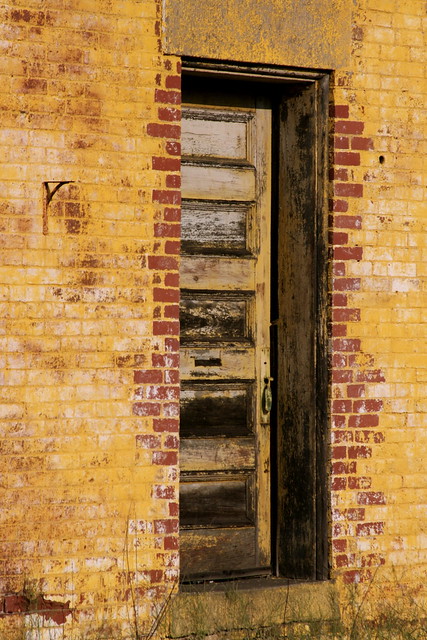 Old door on yellow bricks.