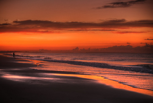 orange sun beach water sunrise person fisherman sand waves glow northcarolina oakisland