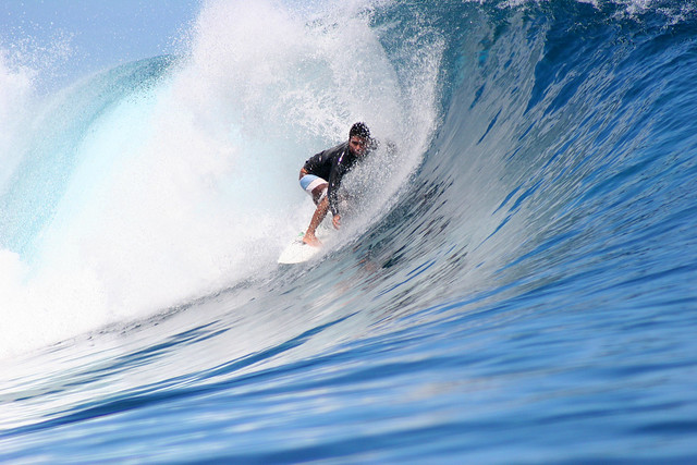 Dennis Tihara surfing the waves at Teahupoo, Tahiti.