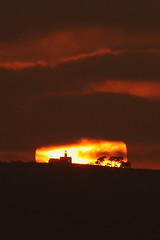 Sunset over the Cabrillo National Monument.  Note the sun is right behind the old Point Loma Lighthouse.  Seen from Silver Strand State Beach.