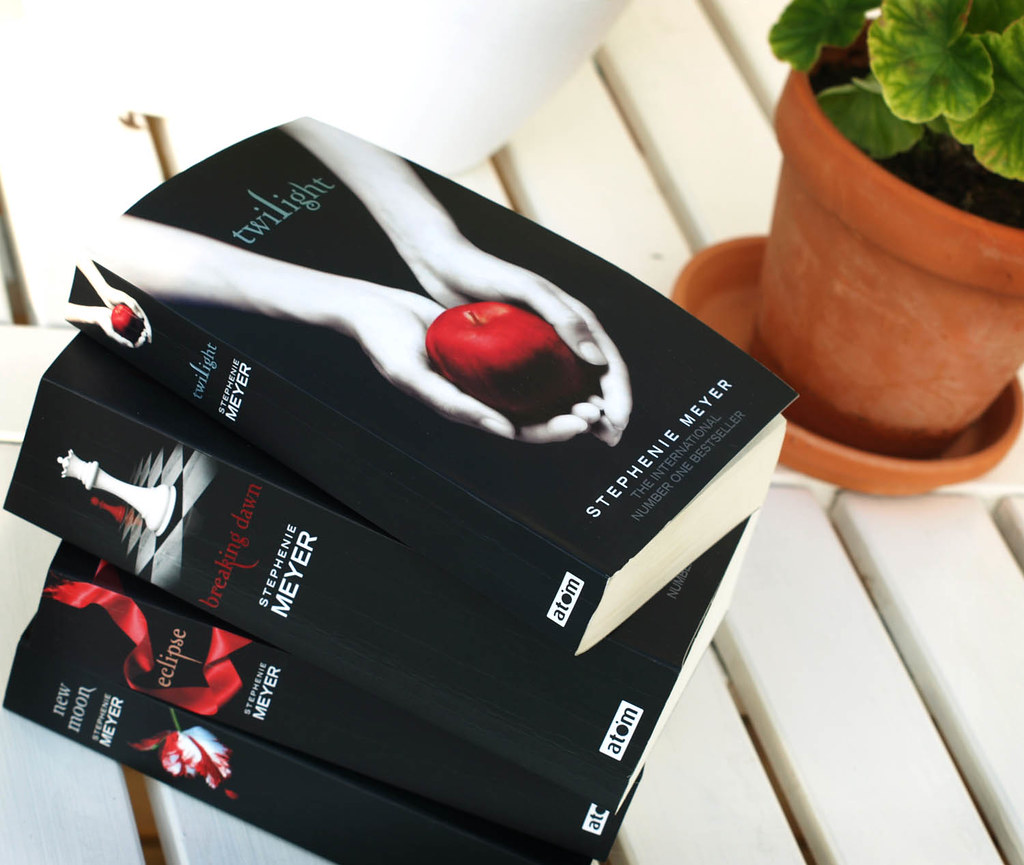 The first four twilight books in a stack on a white porch