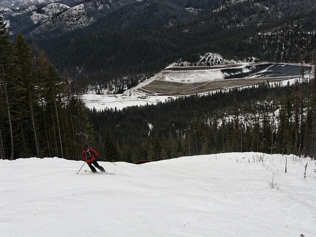 Skier on Mogul Run with Hard Rock Tailings Pit in the Background