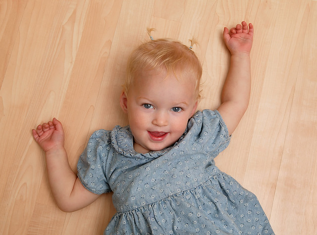 Playful toddler on hardwood floor