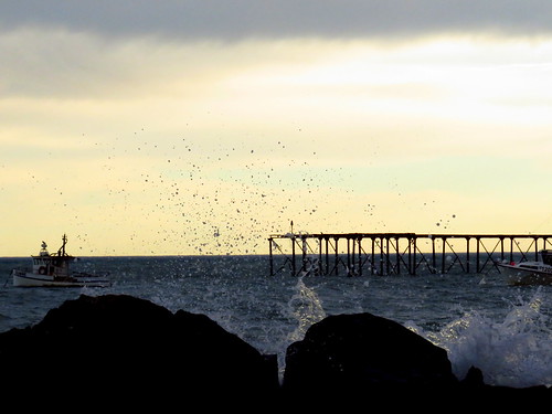 splash ocean sea water coast rocks boat fishingboat sunrise morning light sky clouds pier wharf moerakivillage holiday newzealand nz aotearoa shore seaside seascape seashore beach kiwi profile outline darkshape shadow figure beachscape beachscene beaches canonpowershotsx700hs silhouettes seascapes