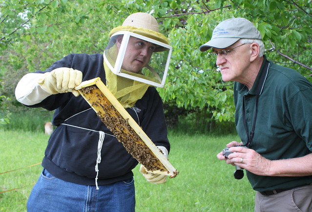 Scott showing off one of his honey frames to his Dad.