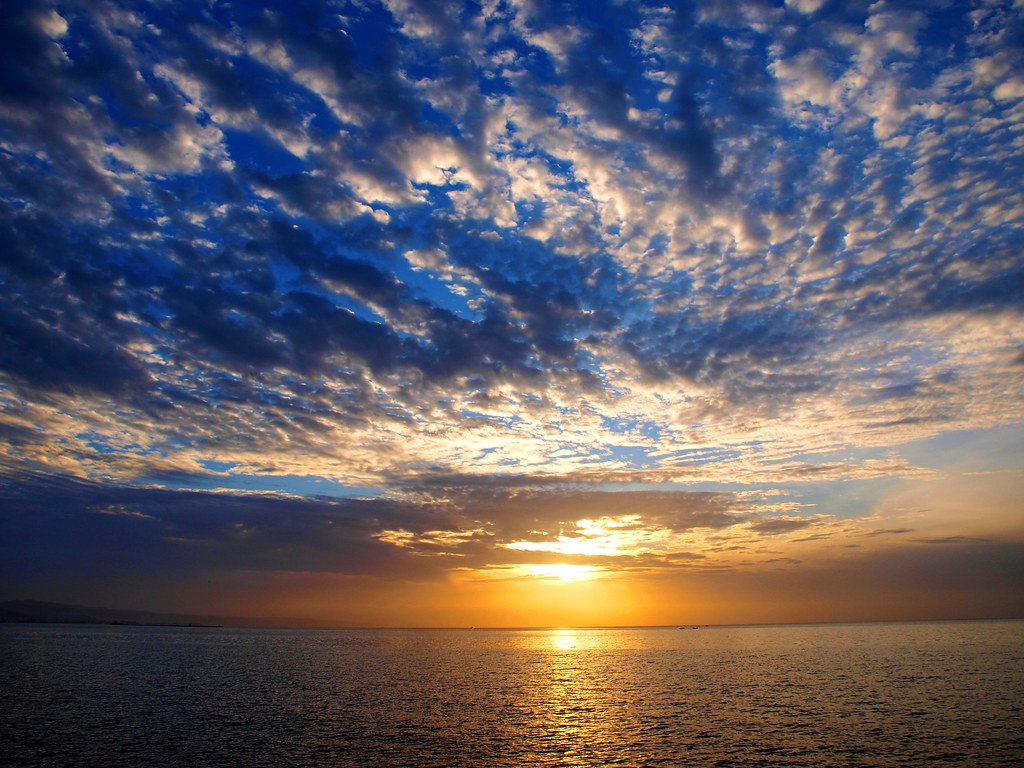 Sunset with massive puffy clouds by Ilias Orfanos