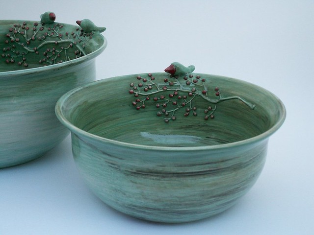 Bowls with birds and red berries