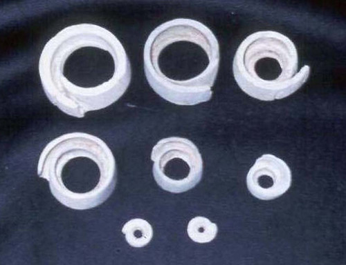 Conus rings made from a cross section of the cone shell ranged in size from tiny beads, as shown in the small conus rings photo, to large bracelet-size circles.  They have been found in various stages of finish – some with the shell designs still evident, like in the conus rings photo, while others were ground down and polished to a smooth, shiny ring.

Judy Flores