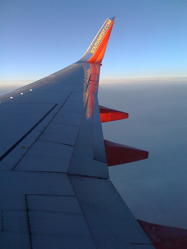 travel sunset reflection window clouds plane airplane fly altitude horizon flight wing southwestairline