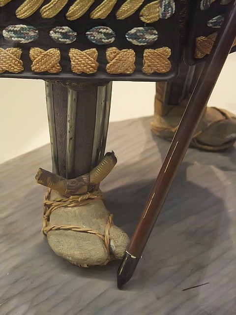 Closeup of footwear of General Kato Magoroku Edo Period Japan 1770 CE terracotta heads and hands brocade fabric and metal armor (2)