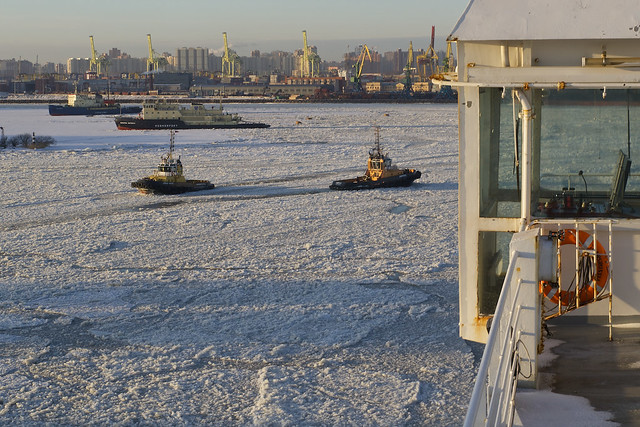 tug boats on iced harbour on winter, St. Petersbourg, Russia