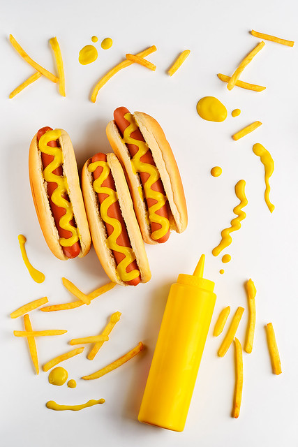 Mustard bottle and hot dogs