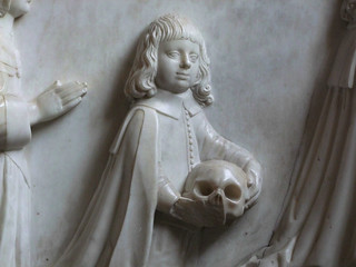 left holding the skull