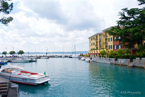 italy lombardy lakegarda sirmione scaligercastle village town harbor lake lakeside water boat clouds nikon d60 boats italian trees gsb