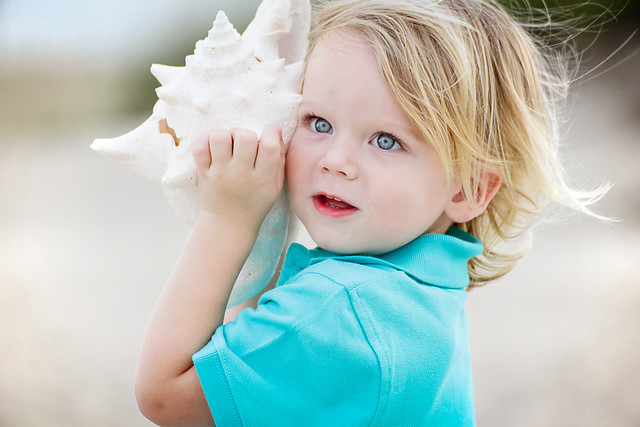 boy with sea shell