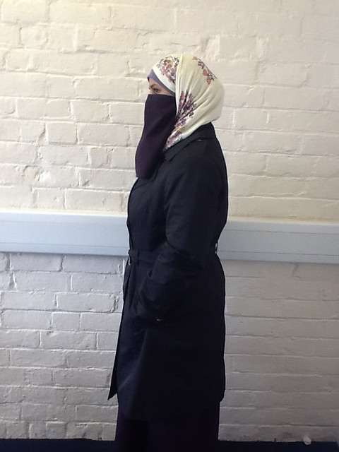 A lady in niqab and a coat