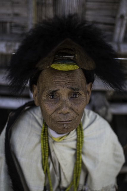 nyishi tribesman wearing the traditional head-dress having a hornbill beak, arunachal pradesh