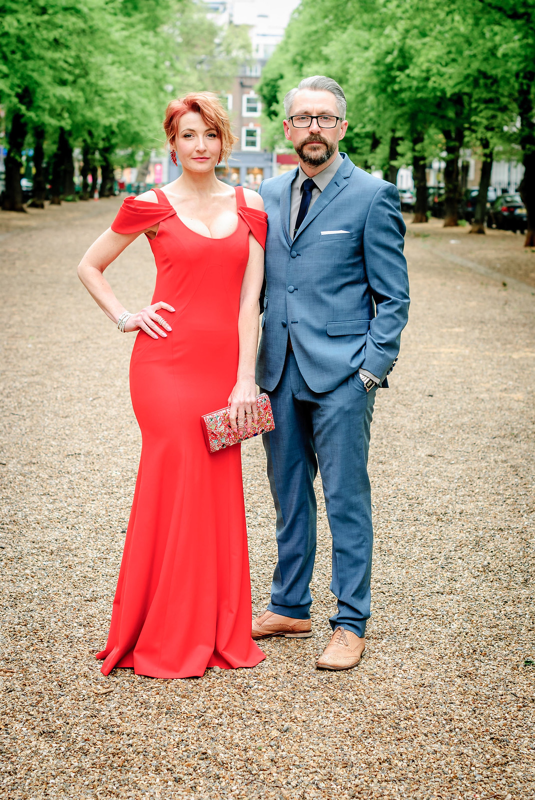 Awards ceremony outfit - Her: Long red fitted gown with shoulder detail \ Him: Mid blue suit with dark tie and tan brogues | Not Dressed As Lamb, over 40 style
